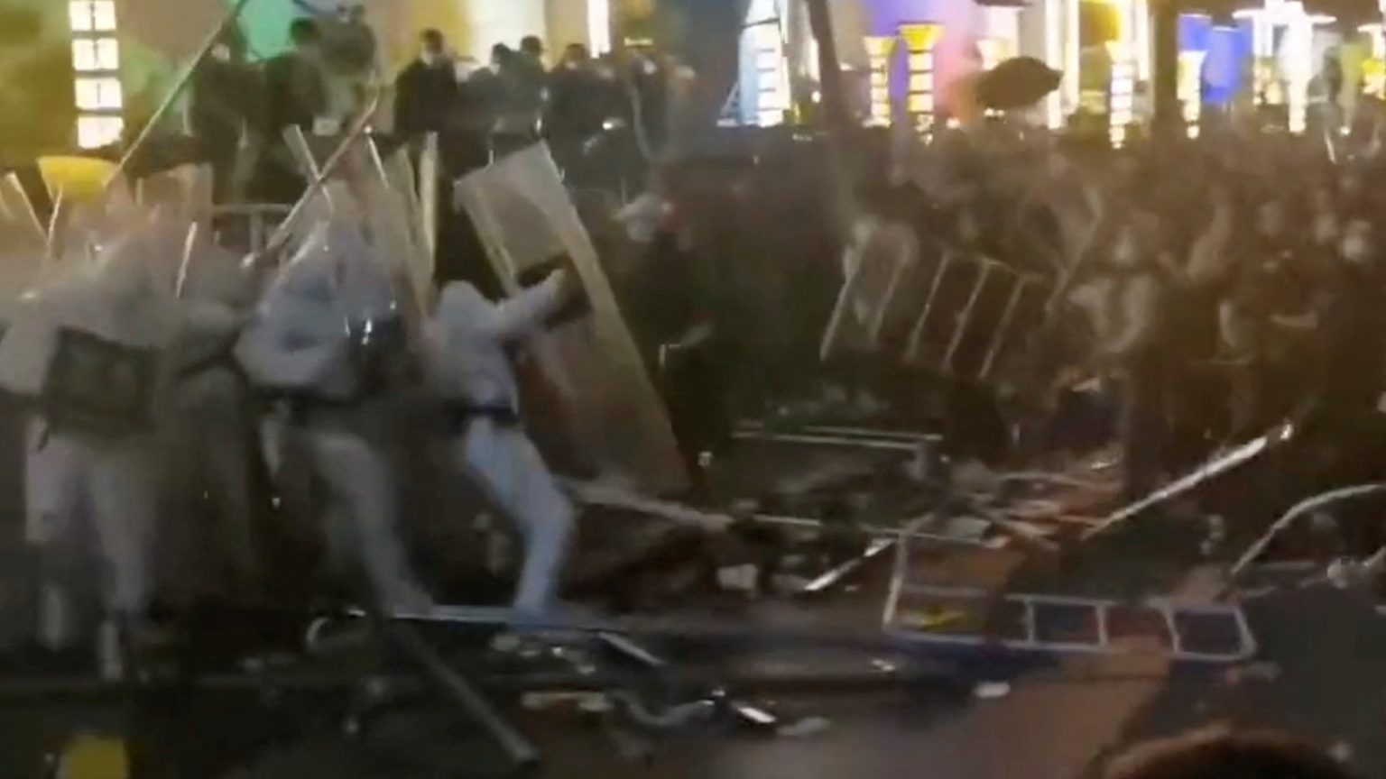 Second employees at world’s greatest iPhone manufacturing facility assault cops in hazmat fits with steel railings as riots get away Moment workers at world's biggest iPhone factory attack cops in hazmat suits with metal railings as riots break out